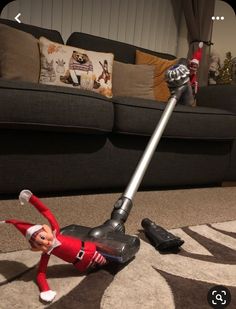 an elf is laying on the floor with a vacuum