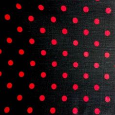 red and black polka dots are on the surface of a piece of cloth that has been made into a pattern