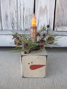 a wooden box with a lit candle in it