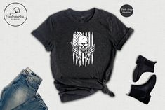 a t - shirt with the image of a skeleton holding an american flag on it