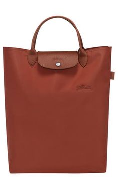 Embossed leather trims this must-have tote made of recycled canvas and furnished with a spacious interior perfect for storing your daily essentials. Magnetic-snap flap closure Top carry handles Two interior wall pockets Structured silhouette with flat base for stability Lined Recycled polyamide with leather trim Imported Rectangular Cognac Bag With Snap Closure, On-the-go Cognac Bag With Leather Trim, Cognac Leather Trim Bag For On-the-go, Cognac Shopping Bag With Leather Trim, Cognac Bags With Leather Trim For Shopping, Cognac Leather Trim Bag For Shopping, Coated Canvas Bag With Snap Closure For Shopping, Coated Canvas Shopping Bag With Snap Closure, Coated Canvas Bags With Snap Closure For Shopping