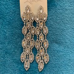 Beautiful And Elegant. Perfect For A Wedding. 3 1/2 Inches Long And Just Under 1 Inch Wide. New With Tags. For Pierced Ears. These Lovely Earrings Will Add Some Serious Sparkle. Wear Them To Add A Classic Flair To Any Outfit Or Affair. All Items Packed Carefully In Recycled Material. No Returns. Glamorous Rhinestone Bridal Earrings For Wedding, Dangle Jewelry With Bling For Wedding, Dangle Bling Jewelry For Wedding, Dangle Crystal Earrings With Bling For Wedding, Glamorous Rhinestone Chandelier Earrings For Anniversary, Bling Dangle Crystal Earrings For Wedding, Glamorous Wedding Crystal Earrings With Diamond Accents, Glamorous Crystal Earrings For Weddings, Wedding Crystal Earrings With Bling