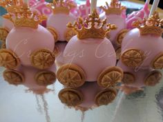 pink and gold cake pops with crowns on them