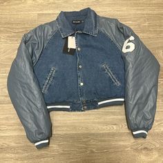 Blue Wash Varsity Denim Jacket Sporty Denim Outerwear For Streetwear, Blue Denim Jacket For Fall Streetwear, Sporty Cotton Denim Jacket For Streetwear, Trendy Denim Blue Outerwear For Streetwear, Blue Outerwear For Spring Streetwear, Sporty Denim Winter Outerwear, Sporty Winter Denim Outerwear, Sporty Long Sleeve Denim Jacket, Trendy Blue Outerwear For Streetwear