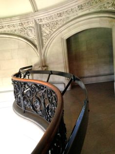 an ornate iron and wood railing in a building