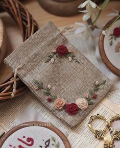 some flowers are sitting on top of an old book next to scissors and other crafting supplies