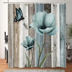 a blue flower on a wooden fence with a butterfly flying over it shower curtain set