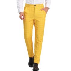 a man wearing yellow pants and a white shirt is standing with his hands in his pockets