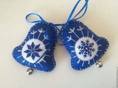 two pieces of blue fabric with white and black designs hanging from it's sides