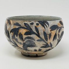 a black and white bowl sitting on top of a table