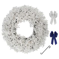 a white wreath with blue bows and an umbrella next to it on a white background