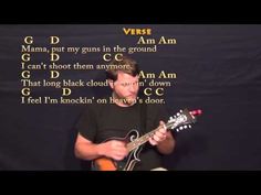 a man playing an acoustic guitar in front of a poem