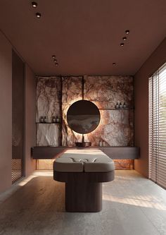 a large round mirror on the wall above a bench in front of a stone wall