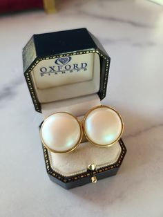 "These are a vintage pair of faux pearl circular clip-on earrings set in a gold tone metal.  Hallmarks: NONE  Weighs: .7oz  Measures 1\" x 1\" inches  All measurements are approximate.  Condition: Good vintage condition. Normal wear associated age. A few light surface scratches and slight discoloration. Please see photos. Sold as is. Priced accordingly.  Please look over carefully and inspect any and all photos. Our shop is committed to fully disclosing all items' conditions and history with as great of detail as possible. please consider this when examining all items in our shop. Simple wear and tear is normal for all vintage pieces.  Your jewelry will be packaged in a kraft gift box perfect for giving.  Some pictures are enlarged to show detail.  Does not include any props in photos.  Pl Luxury Clip-on Round Jewelry, Classic Round Pearl Clip-on Earrings, Classic Pearl Drop Clip-on Earrings, Round Clip-on Pearl Earrings, Classic Clip-on Pearl Drop Earrings, Classic Round Clip-on Earrings With Pearl Drop, Classic Round Pearl Drop Clip-on Earrings, Formal Round Pearl Drop Clip-on Earrings, Vintage Pearl Clip-on Earrings For Gift