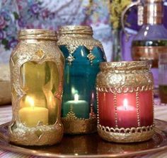 there are many jars with candles in them