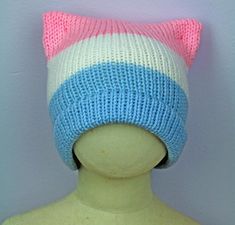 a mannequin head wearing a knitted hat with pink, blue and white stripes