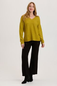 Our favorite sweater knit is back with this v-neck long sleeve, rib detailed pullover. Featuring front pockets and a slight high-low hem. Mirelli Knit: 74/22/4 Acrylic/Polyester/Spandex. Center Front: ~17.25". Center Back: ~24". Color Description: Vibrant faded lime. Preshrunk. Machine washable. Imported. MODEL Hunter is wearing size Small. Height: 5'10" | Bust: 32C | Waist: 25 | Hip: 36 Fall V-neck Sweater With Pockets, Long Sleeve V-neck Sweater For Work, Relaxed Fit V-neck Sweater For Work In Fall, Winter Workwear Tops With Side Pockets, V-neck Sweater With Pockets For Layering, V-neck Sweater With Pockets For Work, V-neck Sweater With Pockets For Winter, V-neck Knit Sweater With Pockets, Casual V-neck Sweater With Pockets