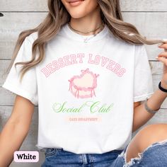 Rep your love for dessert and cake with this Dessert Lovers (Cake Department) tee. This shirt is a perfect versatile addition to your wardrobe whether you're running errands, having brunch with friends, enjoying a theme park, or taking a baking class.  ✨ This shirt has a relaxed fit -- for a trendy oversized look we recommend sizing up, for a closer fit we recommend sizing down or staying true to size. Consult our size chart and color palette for more detailed sizing and color options. ✨ Please note, the design is scaled to the t-shirt size, so on smaller shirts the design itself may appear smaller. 🎀 Comfort Colors is a premium, soft tee that is garment dyed for a vintage look. Due to this, there may be slight variations in color.  🎀 The Comfort Colors 1717 tee is made with medium fabri Cake T Shirt, Sweet White T-shirt With Graphic Print, Sweet White Short Sleeve T-shirt, Sweet White T-shirt With Funny Print, White Sweet T-shirt With Funny Print, Sweet Crew Neck T-shirt For Gift, Sweet Letter Print T-shirt For Gift, Shirt Cake, Dessert Lover