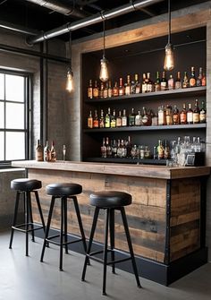 a bar with stools and bottles on the shelves