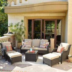 an outdoor living area with furniture and potted plants