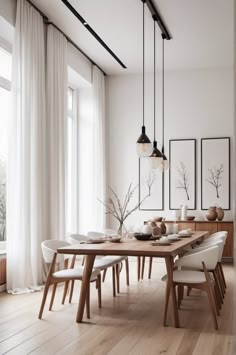 a dining room with white walls and wooden floors