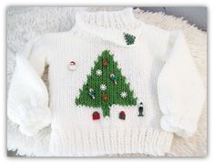 a white sweater with a green christmas tree on it