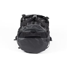 the back view of a black duffel bag on a white background with straps hanging from it