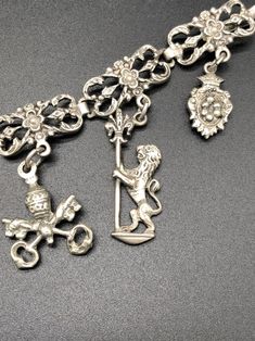 "Super Old European Sterling Silver Charm Bracelet with Charms Antique 7.25\" long Please see pictures of all the charms. Feel free to ask any questions! Layaway Available. Tons of jewelry coming up for sale. I love to combine shipping on multiple items, and am happy to ship internationally. International bidders, please contact me with your location for a shipping quote. If there is anything wrong once the item is received and you are not happy, please contact me before leaving negative feedbac Ornate Jewelry Charms For Collectors, Ornate Collectible Charms Jewelry, Silver Bracelets With Dangling Charms, Silver Bracelets With Dangling Pendant Charms, Elegant Silver Vintage Charms, Sun Belt, Bracelet With Charms, Sterling Silver Charm Bracelet, Cluster Necklace