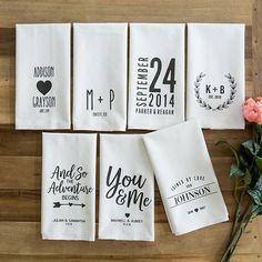 six personalized tea towels on a wooden table