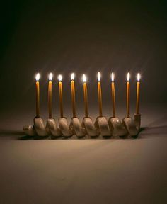 a group of lit candles sitting in front of each other