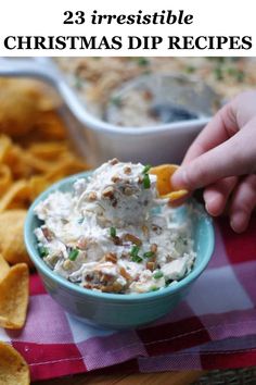 a person dipping dip into a bowl with crackers