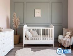 a baby's room with pink walls and white furniture