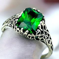 Unlock the timeless elegance of our Vintage Emerald CZ Solitaire Ring, a stunning piece crafted from 925 solid sterling silver. Adorned with exquisite filigree detailing, this ring is not just a piece of jewelry; it's a heartfelt expression of love, perfect for birthdays or anniversaries. The striking emerald-inspired gemstone, the birthstone of May, captures the eye and elevates any outfit. Surprise someone special or treat yourself to a symbol of enduring beauty and elegance. Embrace your unique style--add this enchanting ring to your collection today! Excellent Condition, Satisfaction Guaranteed! May Birthstone Emerald Rings With Intricate Design For Anniversary, Classic Crystal Birthstone Ring For Formal Occasions, Formal Silver Crystal Ring With Birthstone, Filigree Ring For May Birthstone Gift, May Birthstone Filigree Ring Gift, Engraved Emerald Cut Jewelry Gift, Silver May Birthstone Ring For Formal Occasion, Elegant Silver Crystal Ring For May Birthstone, Classic Silver Emerald Ring For Anniversary