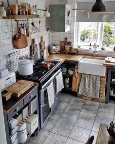 the kitchen is clean and ready to be used for cooking or baking, with dishes on the table