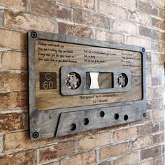 an old fashioned cassette player mounted to a brick wall