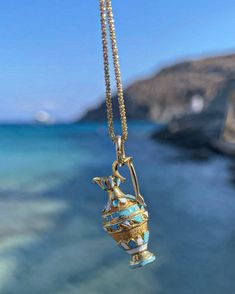 Please be advised that this order is MADE TO ORDER. Please allow 6-8 weeks for production. Channel your inner ancient Greek Goddess with these handcrafted pendants.  Handcrafted of solid 14 karat solid gold, this pendant features a Grecian vase with baked enamel blue & white finishes and filigree work.  Attached to a 20 inch curb link cabin.  Weighs 7 grams.  Measures just over one inch long. The Grecian Vase or Amphora is typically a one or two handled vessel used to transport olive oil and win Handmade 14k Gold Amulet Necklace, Traditional 14k Stamped Medallion Necklace, Traditional 14k Stamped Pendant Necklace, Ceremonial Artisan Yellow Gold Jewelry, Unique Yellow Gold Necklace For Ceremonial Use, Traditional 14k Stamped Necklace For Gift, Traditional 14k Stamped Necklace As Gift, Artisan Engraved Yellow Gold Necklace, Ceremonial 14k Stamped Pendant Jewelry