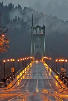 an image of a bridge that is lit up in the rain with candles on it