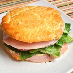 a sandwich with ham, lettuce and cheese