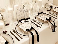 the table is set with black and white place settings