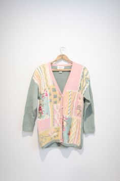 "maker: cervelle material: raimie cotton fits like a n oversized small/medium used vintage condition length: 30\", pit to pit:25\", shoulders:25\", shoulder to wrist:20\"" Vintage Green Knit Outerwear, Vintage Floral Print Spring Cardigan, Vintage Long Sleeve Sweater With Floral Print, Vintage Floral Print Cardigan For Winter, Vintage Floral Print Cardigan For Fall, Vintage Floral Print Winter Cardigan, Vintage Winter Floral Cardigan, Fall Vintage Floral Print Cardigan, Pink Floral Print Sweater For Spring