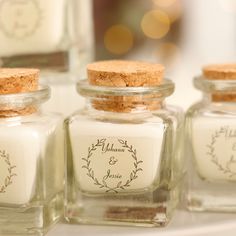 three small glass bottles with labels on them