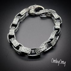 925 Sterling silver rectangular links form the geometric chain of this Celtic modern men's Bracelet. Each rounded, double-sided link of the handcrafted interlocking chain is Greek patterns based on armor designs dating back 3500 years.  The sterling silver rectangles add a sleek vibe of modern day affluence. Size: 9 inches long and 6mm thick. 71.8 grams Material: 925 Sterling Silver. Modern Engraved Link Chain Bracelet, Modern Engraved Oval Link Bracelets, Modern Engraved Bracelets With Oval Links, Sterling Silver Bracelet With Rectangular Links, Silver Bracelets With Rectangular Chain Links, Silver Engraved Jewelry With Rectangular Links, Silver Jewelry With Engraved Rectangular Links, Engraved Silver Jewelry With Rectangular Links, Engraved Metal Bracelet With Oval Links