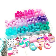 a box filled with lots of different types of beads and charms on top of a table