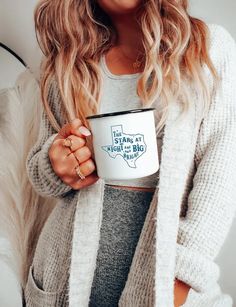 a woman holding a coffee mug in her hands