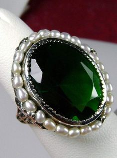 Emerald Ring, Seed Pearls surround and accent the simulated oval stone with sterling silver Victorian filigree Exquisite Oval Green Emerald Ring, Exquisite Green Oval Emerald Ring, Elegant Silver Crystal Ring For May Birthstone, Exquisite Green Emerald Ring, Elegant Green Crystal Ring For Formal Occasions, Formal Emerald Ring With Stone Setting, Classic Green Crystal Ring For Formal Occasions, Elegant Jeweled Promise Ring, Elegant Jewel Promise Ring