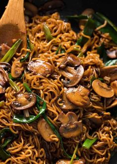 noodles with mushrooms and green peppers are served on top of each other in a bowl