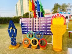 the olympic rings are on display in front of an advertising sign and fire hydrant