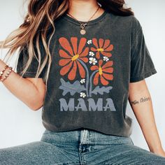 "The most adorable boho Mama shirt there is!  Perfect for everyday!  Everyone's favorite Tee! Comfort Colors makes the perfect tee for both traditional and oversized styling! Soft-washed fabric brings extra coziness to your wardrobe while the relaxed fit makes it the perfect daily choice. .: 100% ring-spun cotton .: Medium fabric (6.1 oz/yd² (206.8 g/m .: Relaxed fit **PLEASE NOTE** - Rolled Sleeves in photos are for styling purposes only - Props use in photos are not included or available for p Multicolor Bohemian Relaxed Fit T-shirt, Bohemian Cotton Top With Relaxed Fit, Bohemian Cotton Top, Bohemian Multicolor Relaxed Fit T-shirt, Bohemian Style Multicolor Relaxed Fit T-shirt, Artsy Printed Cotton Tops, Hippie Cotton Tops With Boho Print, Hippie Style Cotton Tops With Boho Print, Hippie Boho Print Cotton Tops