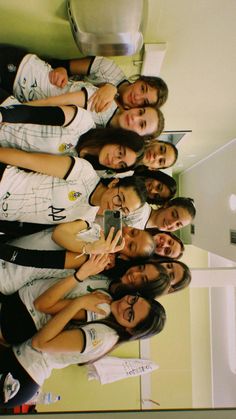 a group of young women standing next to each other in front of a white wall