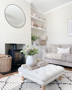 a living room filled with furniture and a fire place in the middle of the room